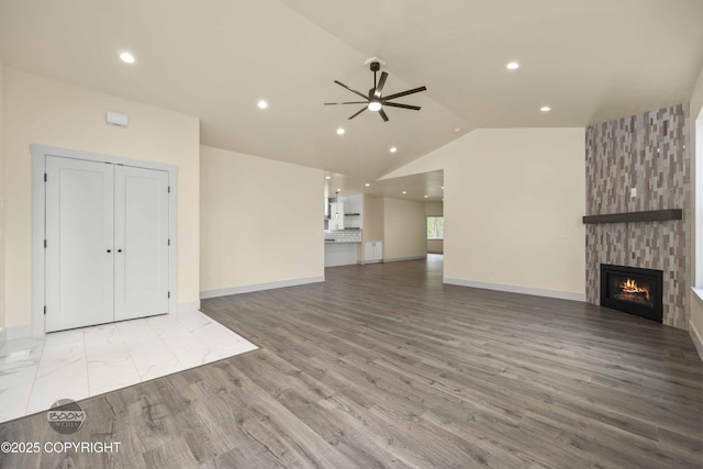 7254 E Riparian Loop, Palmer, AK 99645 - unfurnished living room featuring a ceiling fan, a fireplace, lofted ceiling, recessed lighting, and wood finished floors