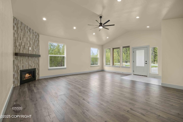 7254 E Riparian Loop, Palmer, AK 99645 - unfurnished living room featuring ceiling fan, recessed lighting, lofted ceiling, wood finished floors, and a fireplace