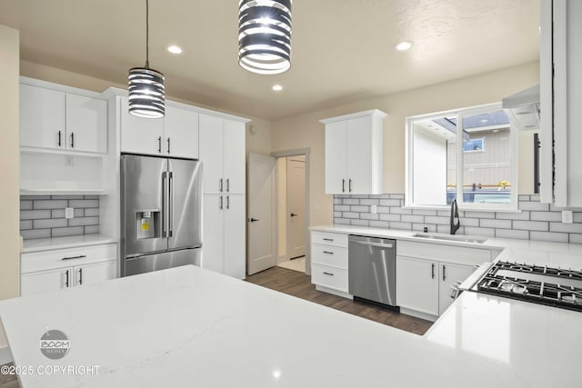 7254 E Riparian Loop, Palmer, AK 99645 - kitchen featuring appliances with stainless steel finishes, a sink, dark wood-type flooring, backsplash, and recessed lighting