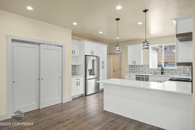 7254 E Riparian Loop, Palmer, AK 99645 - kitchen with appliances with stainless steel finishes, a sink, backsplash, a peninsula, and recessed lighting