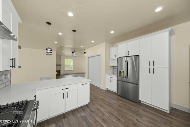 7254 E Riparian Loop, Palmer, AK 99645 - kitchen with stainless steel appliances, a peninsula, dark wood finished floors, white cabinetry, and recessed lighting