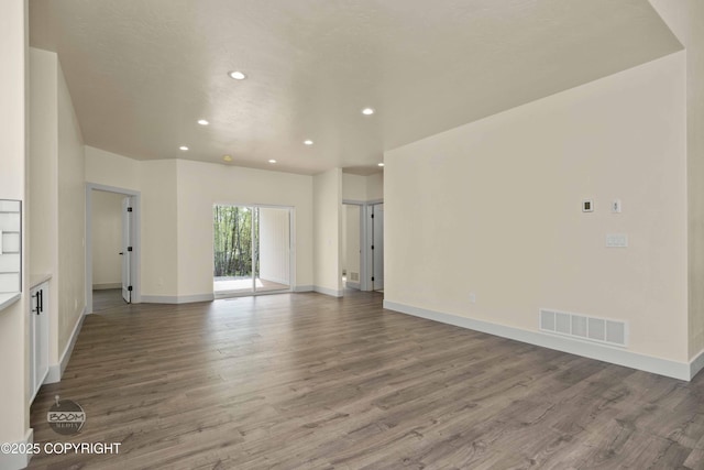 7254 E Riparian Loop, Palmer, AK 99645 - unfurnished living room featuring recessed lighting, wood finished floors, and baseboards