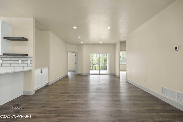 7254 E Riparian Loop, Palmer, AK 99645 - unfurnished living room featuring recessed lighting, dark wood-type flooring, and baseboards