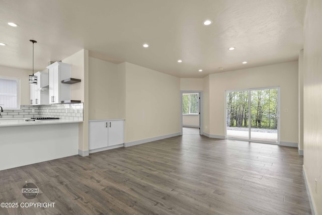 7254 E Riparian Loop, Palmer, AK 99645 - unfurnished living room featuring recessed lighting, plenty of natural light, wood finished floors, and baseboards