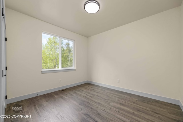 7254 E Riparian Loop, Palmer, AK 99645 - unfurnished room with wood finished floors and baseboards