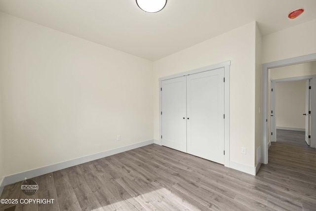 7254 E Riparian Loop, Palmer, AK 99645 - unfurnished bedroom with wood finished floors, baseboards, and a closet