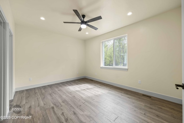 7254 E Riparian Loop, Palmer, AK 99645 - spare room with wood finished floors, ceiling fan, recessed lighting, and baseboards