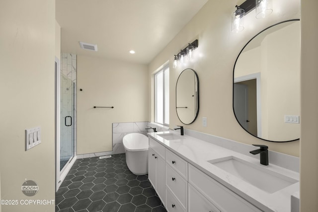 7254 E Riparian Loop, Palmer, AK 99645 - bathroom featuring a stall shower, a soaking tub, tile patterned flooring, double vanity, and recessed lighting