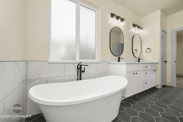 7254 E Riparian Loop, Palmer, AK 99645 - full bathroom with tile walls, double vanity, a freestanding tub, a wainscoted wall, and tile patterned flooring