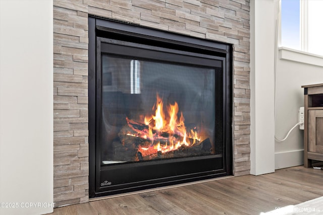 7863 Gate Creek Dr, Anchorage, AK 99502 - detailed view of a glass covered fireplace and wood finished floors
