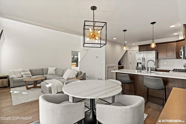 7863 Gate Creek Dr, Anchorage, AK 99502 - dining area with recessed lighting, wood finished floors, stairway, and a chandelier