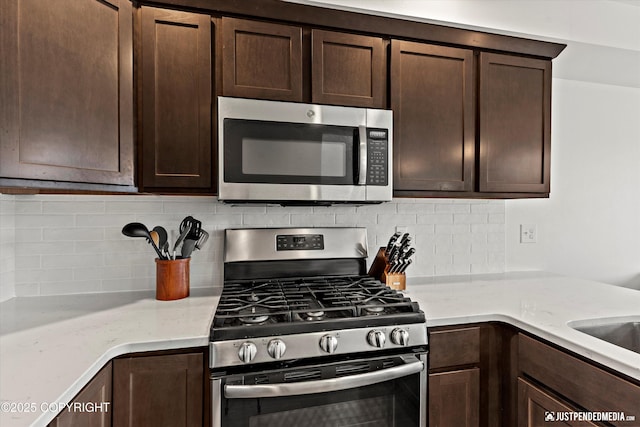 7863 Gate Creek Dr, Anchorage, AK 99502 - kitchen with appliances with stainless steel finishes, dark brown cabinets, decorative backsplash, and light stone countertops