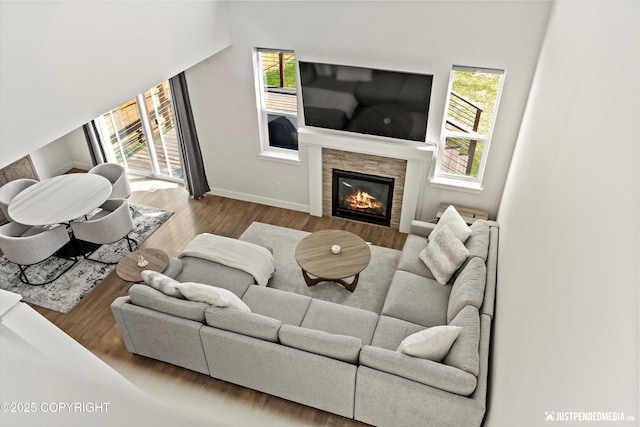 7863 Gate Creek Dr, Anchorage, AK 99502 - living room with healthy amount of natural light, a fireplace, baseboards, and wood finished floors