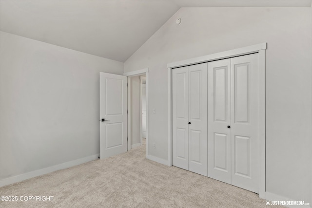 7863 Gate Creek Dr, Anchorage, AK 99502 - unfurnished bedroom featuring vaulted ceiling, carpet floors, a closet, and baseboards