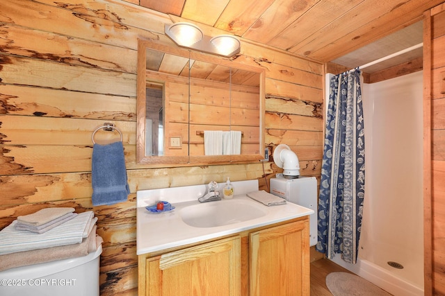 bathroom featuring wood walls, a shower stall, wooden ceiling, vanity, and toilet