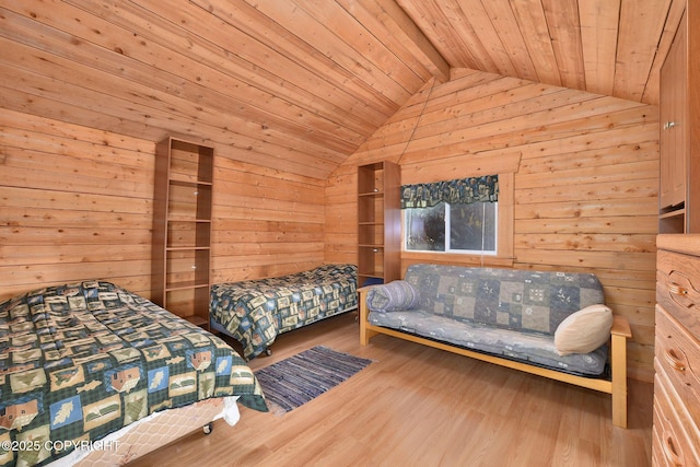 bedroom with wood ceiling, wooden walls, and wood finished floors