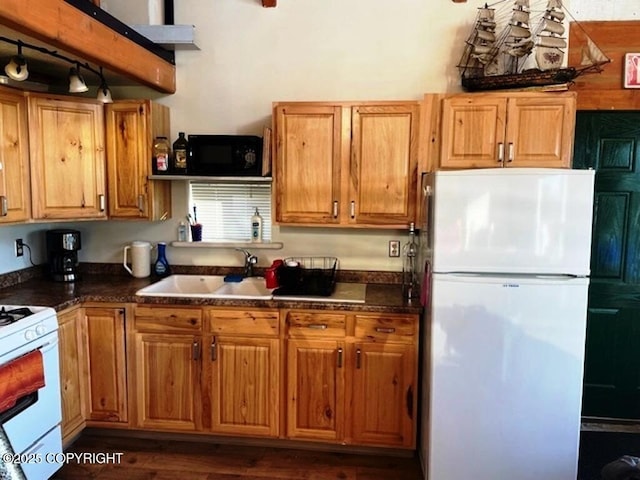 31580 Hannah Rene Rd, Anchor Point, AK 99556 - kitchen featuring white appliances, a sink, dark countertops, and brown cabinetry