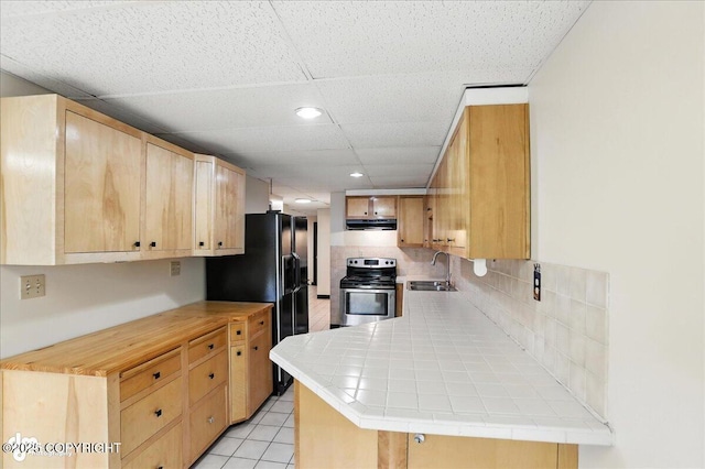 933 W 20th Ave, Anchorage, AK 99503 - kitchen featuring backsplash, stainless steel electric stove, light brown cabinets, black fridge with ice dispenser, and a paneled ceiling