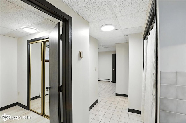933 W 20th Ave, Anchorage, AK 99503 - corridor with a drop ceiling and a baseboard heating unit