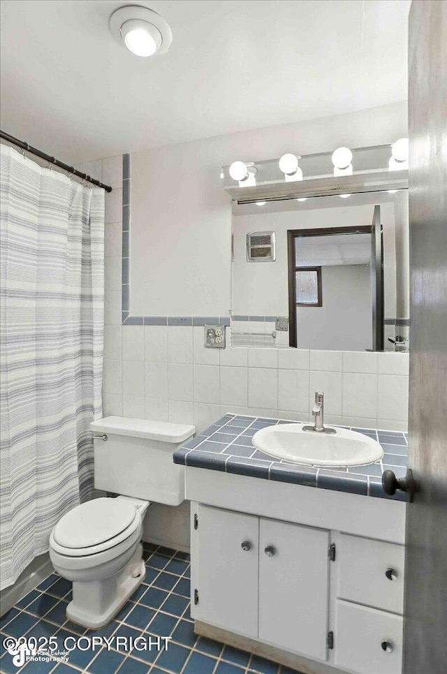 933 W 20th Ave, Anchorage, AK 99503 - full bath with vanity, tile walls, tile patterned flooring, and a shower with curtain