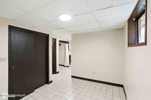933 W 20th Ave, Anchorage, AK 99503 - unfurnished room with a paneled ceiling and baseboards