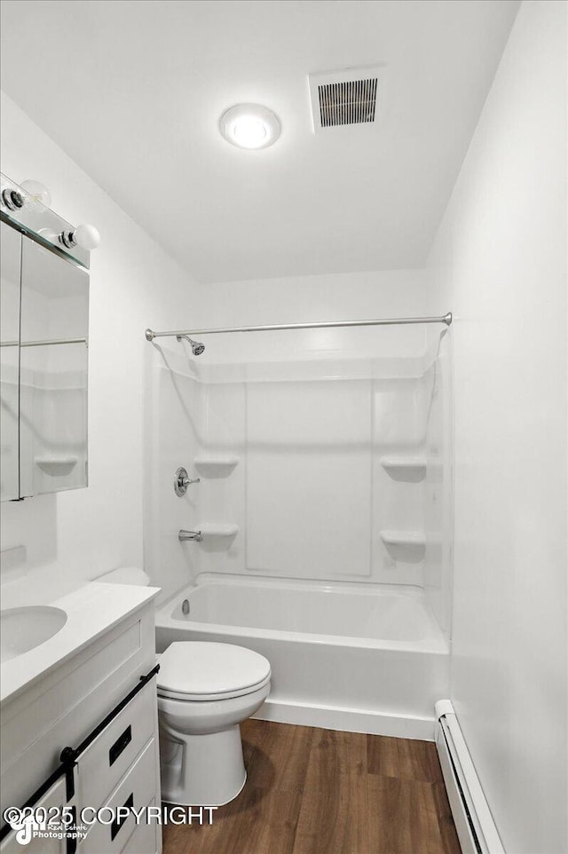 933 W 20th Ave, Anchorage, AK 99503 - full bath with wood finished floors, vanity, shower / washtub combination, and a baseboard radiator