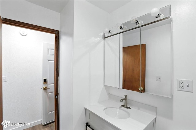 933 W 20th Ave, Anchorage, AK 99503 - bathroom featuring vanity and wood finished floors