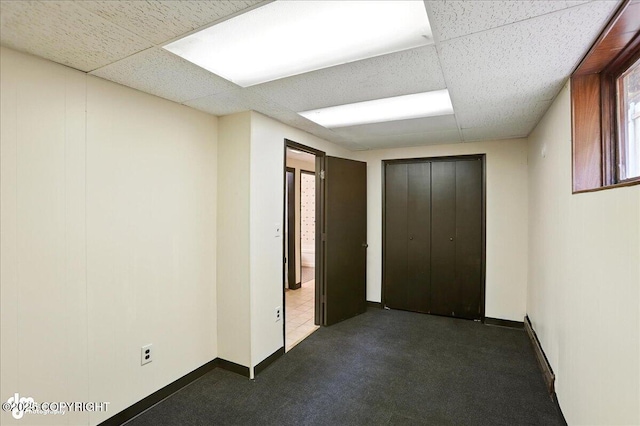 933 W 20th Ave, Anchorage, AK 99503 - unfurnished bedroom with carpet flooring, a closet, and a drop ceiling