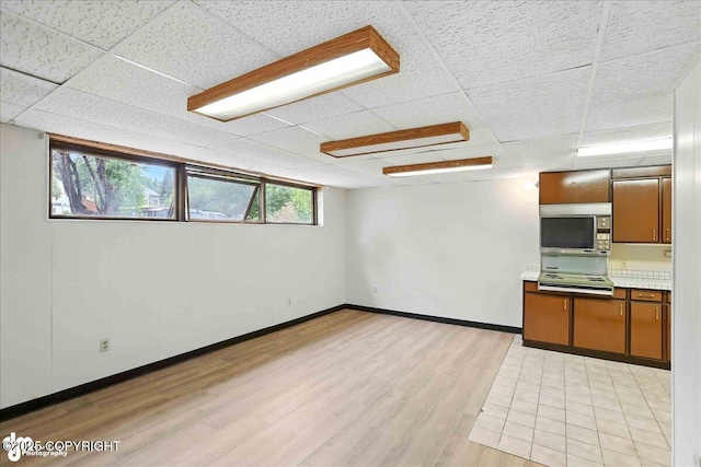 933 W 20th Ave, Anchorage, AK 99503 - below grade area featuring a drop ceiling and light wood finished floors