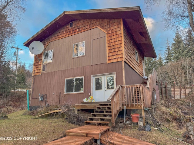 rear view of house with a wooden deck and stairs