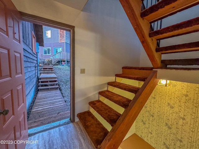stairs featuring wood finished floors