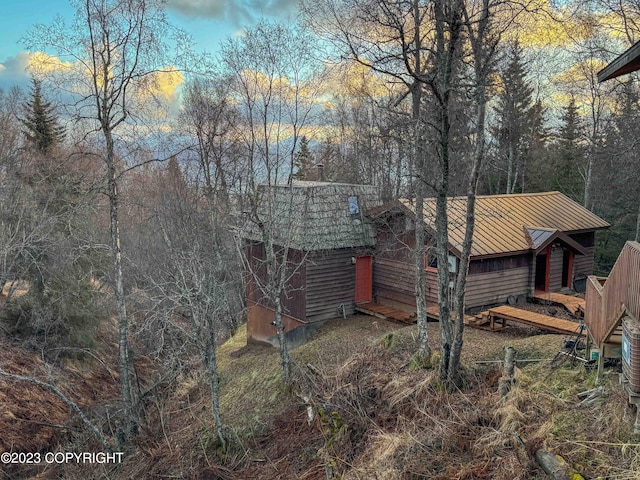view of home's exterior featuring a standing seam roof and metal roof