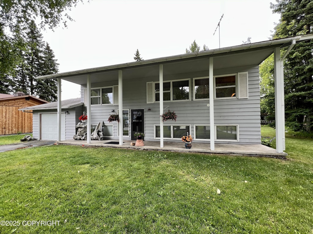 910 Southampton Dr, Anchorage, AK 99503 - back of property featuring asphalt driveway and a yard