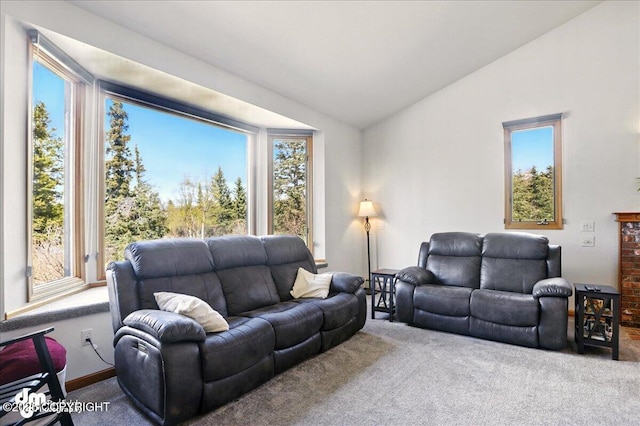 carpeted living area with lofted ceiling