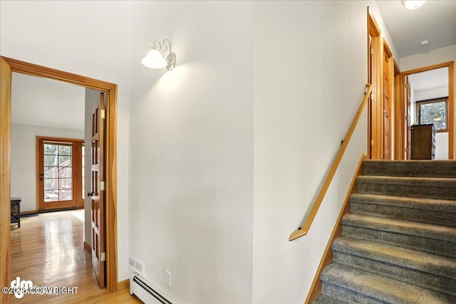 stairway with baseboards and wood finished floors