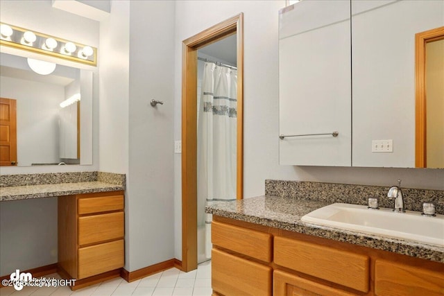 full bathroom with vanity, tile patterned floors, and baseboards