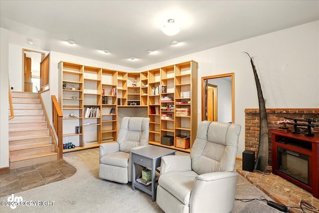 living area featuring stairway and carpet