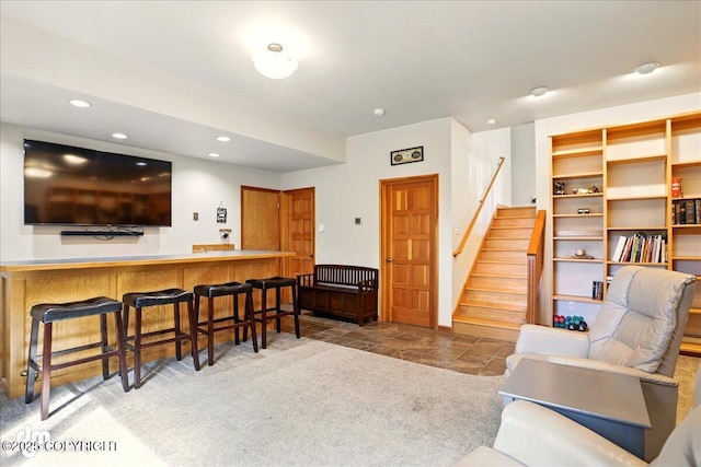 living area with stairs, bar, and recessed lighting