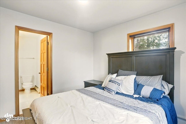 bedroom with a baseboard radiator and ensuite bath