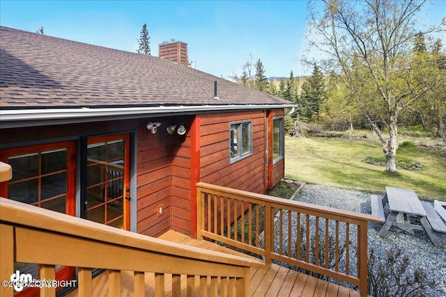 wooden terrace with a lawn
