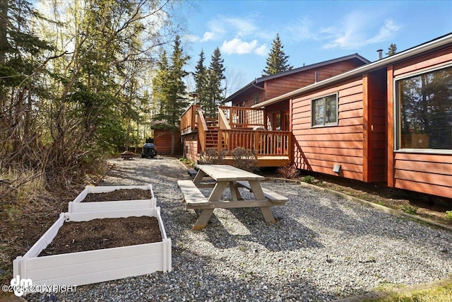view of yard featuring a deck and a vegetable garden
