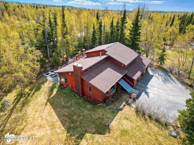 view of subject property with a forest