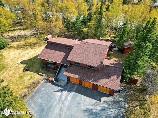 view of subject property with a heavily wooded area