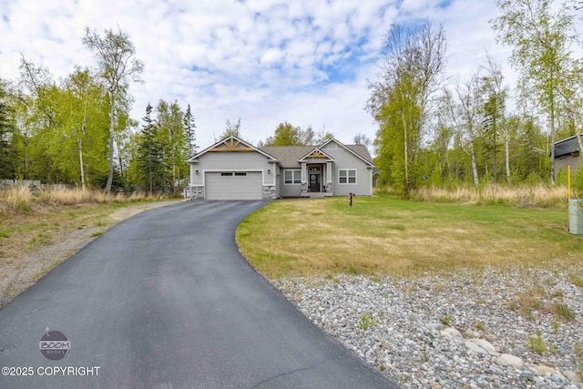 3589 N Magnolia Cir, Wasilla, AK 99654 - view of front of home with a garage, driveway, stone siding, and a front lawn