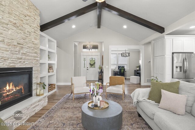 3589 N Magnolia Cir, Wasilla, AK 99654 - living area featuring a chandelier, wood finished floors, a stone fireplace, baseboards, and recessed lighting
