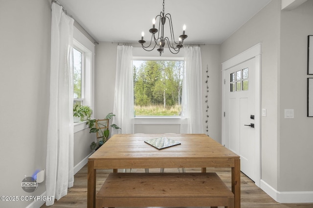 3589 N Magnolia Cir, Wasilla, AK 99654 - dining space featuring wood finished floors, a chandelier, and baseboards