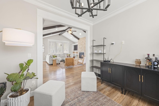 3589 N Magnolia Cir, Wasilla, AK 99654 - bar area featuring light wood-type flooring, a stone fireplace, crown molding, a ceiling fan, and a chandelier