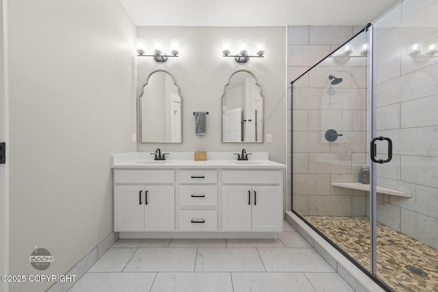 3589 N Magnolia Cir, Wasilla, AK 99654 - full bathroom featuring a shower stall, double vanity, marble look tiles, and baseboards