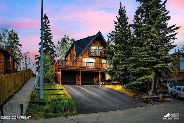 6010 Staedem Dr, Anchorage, AK 99504 - view of front of home featuring asphalt driveway, a balcony, and an attached garage
