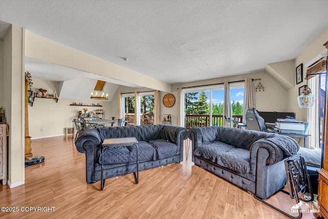 6010 Staedem Dr, Anchorage, AK 99504 - living area featuring light wood finished floors, a chandelier, a desk, a textured ceiling, and baseboards